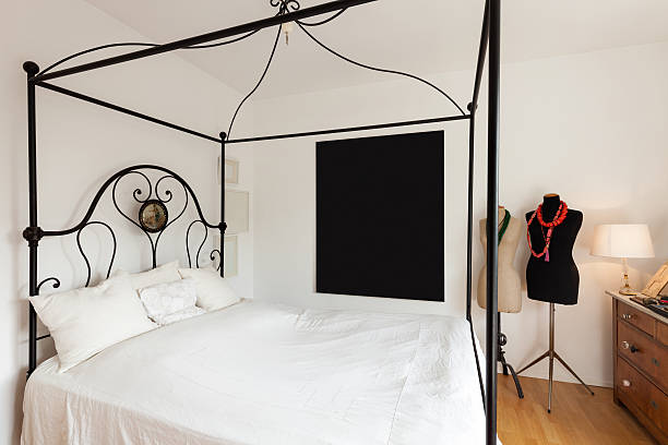 Interior, lovely bedroom with double bed in wrought iron