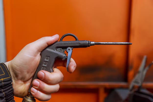 A blow gun in the hand of a worker
