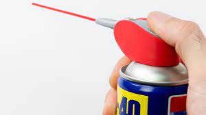 a hand Removing Soft Adhesives with WD-40