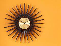 sunburst Wall Clock on yellow wall