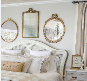 3 mirrors above theheadboard of bed