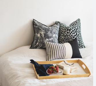 two standard contrasting pillows and 1 lumber on bed