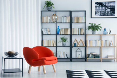 Freestanding shelves and a  chair in room